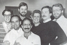 Attached is a photo from the 1980's of Merry Mary and some Windy City Gay Chorus members. Clockwise from the front: Brian David, Rick Solis, McCabe, Tom Patt, Merry Mary, Craig Smith, and Keith Thompson.