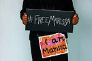 Mariame Kaba with signs.Photo courtesy of Kaba