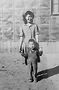 Left: Roy Wesley's mother, Cecilia Wesley (n�e Sasaki), with brother Lee, at Minidoka Internment Camp, Idaho.Photo courtesy of Wesley
